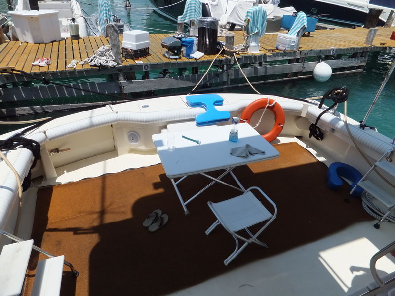 Hatteras 66 ft fishing charter vessel side view at marina showing flybridge and professional deep-sea fishing setup
