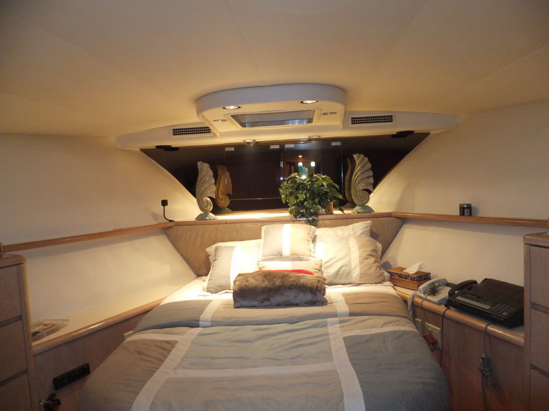 Hatteras 66 ft luxury fishing charter boat at Cancun marina with turquoise Caribbean water and tropical surroundings