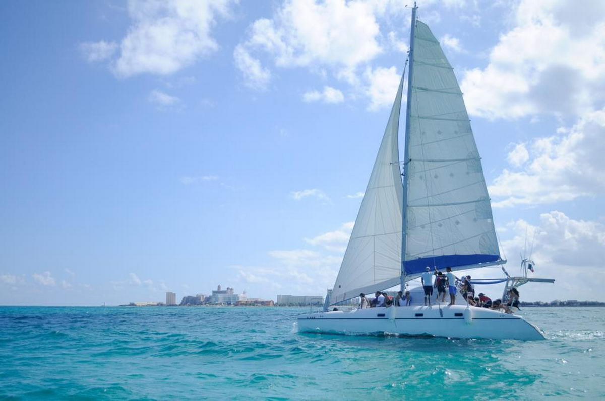 Catmania Blade Runner catamaran deck guests open bar sailing Cancun Caribbean group rental Isla Mujeres
