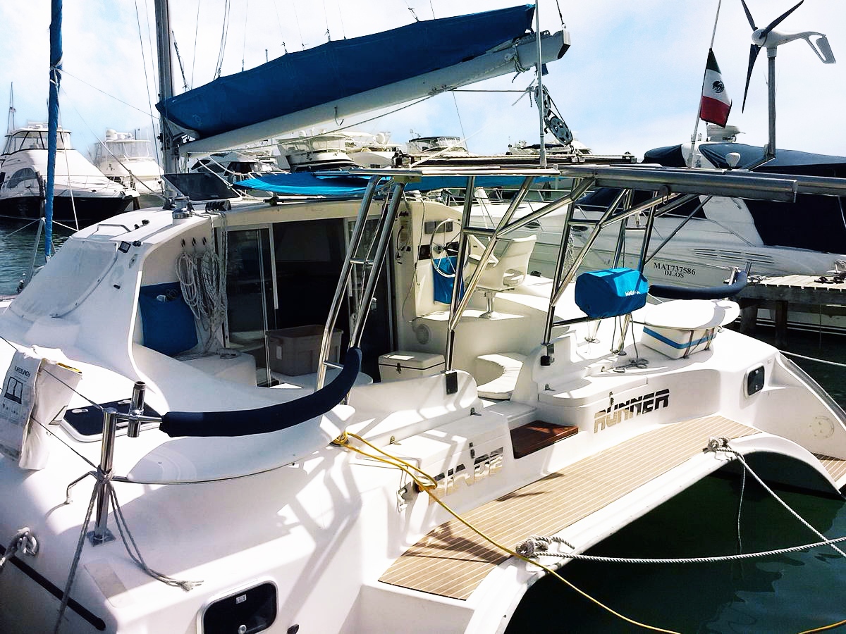 Private catamaran Catmania Blade Runner guests sailing Isla Mujeres turquoise Caribbean Cancun vacation