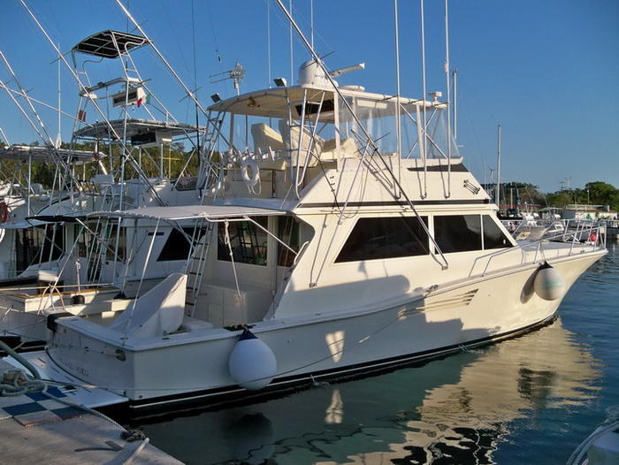 Bertram 38 fishing boat cruising the turquoise Caribbean near Cozumel for private fishing and snorkeling tours