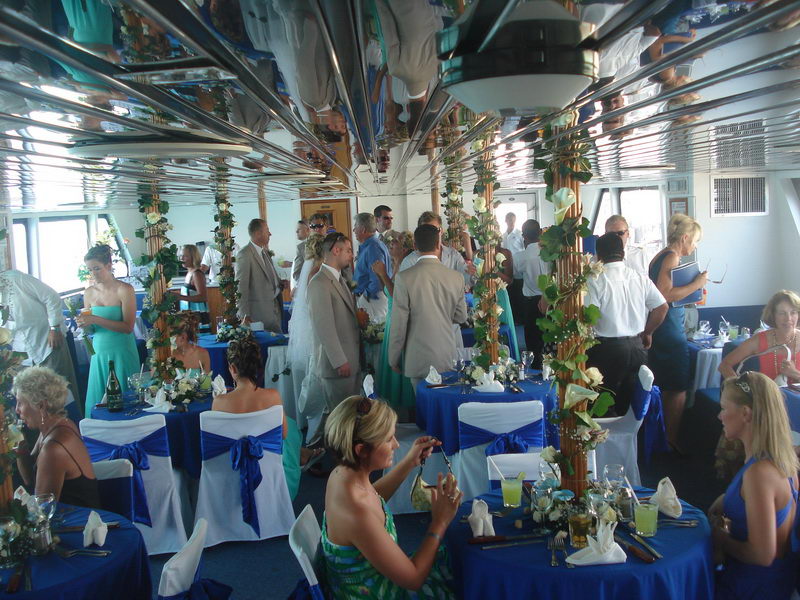 Guests boarding the Discovery boat for a Caribbean wedding under a bright blue sky