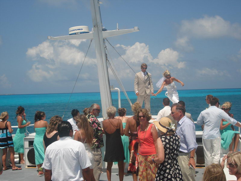 Wedding reception toast aboard the Discovery boat with blue-and-white décor and sea views