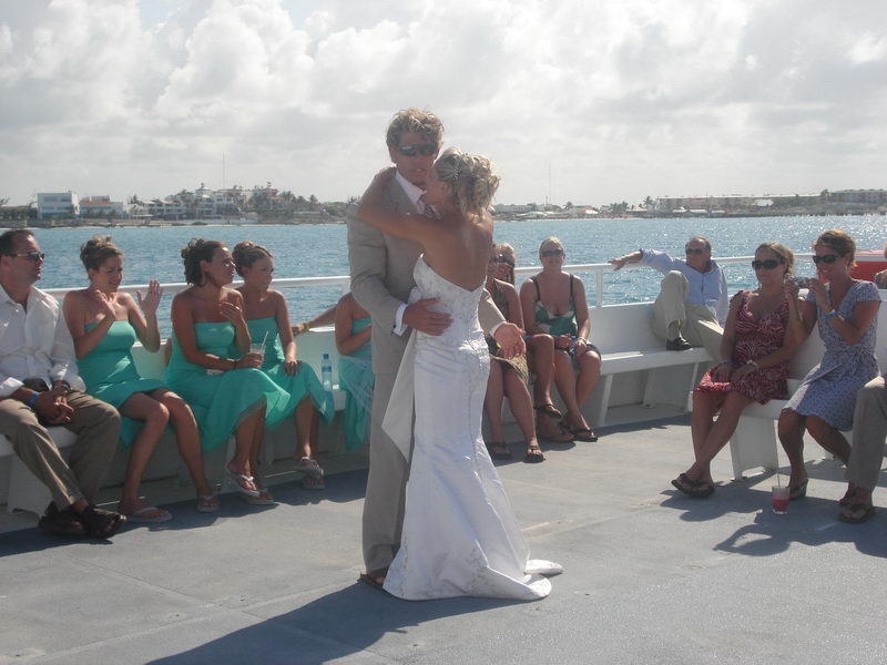 Wedding guests dining and dancing in the decorated salon of the Discovery boat in Cancun