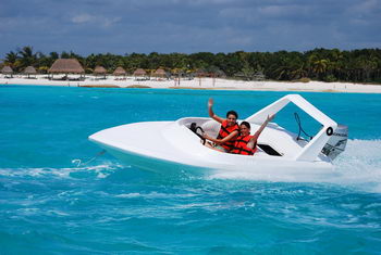 Yellow two-seat jungle-tour speed boats lined up for a mangrove and reef snorkeling tour in Cancun