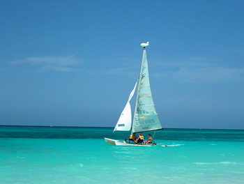 Hobie Cat sailing catamaran skimming across the bright Caribbean off a Cancun beach