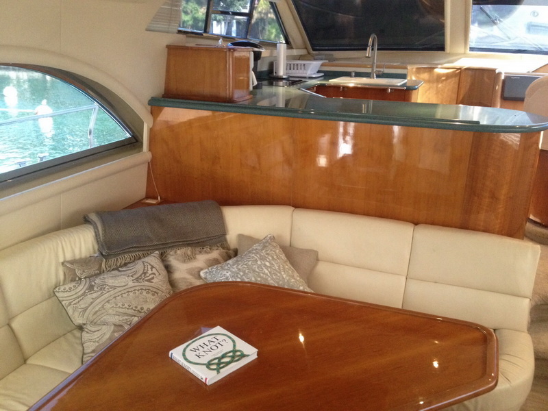Bow deck of the 55ft party boat charter at Puerto Aventuras with guests relaxing, tropical Caribbean scenery