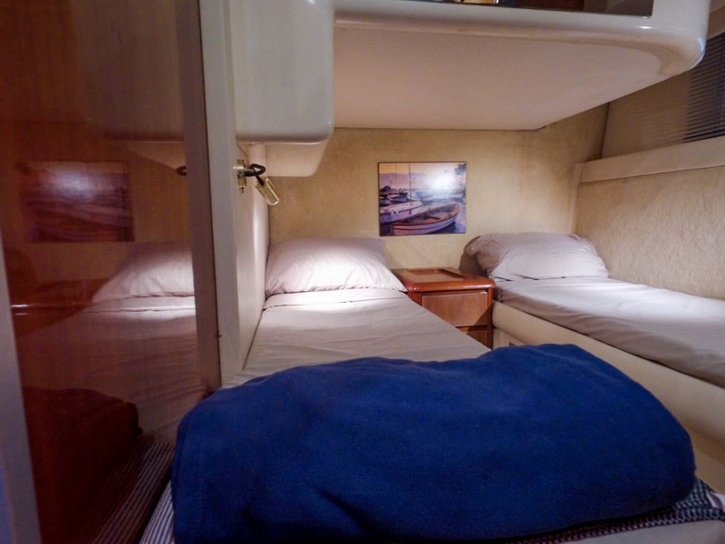 Twin guest cabin with two single beds aboard 48 ft Azimut yacht charter Puerto Aventuras Playa del Carmen