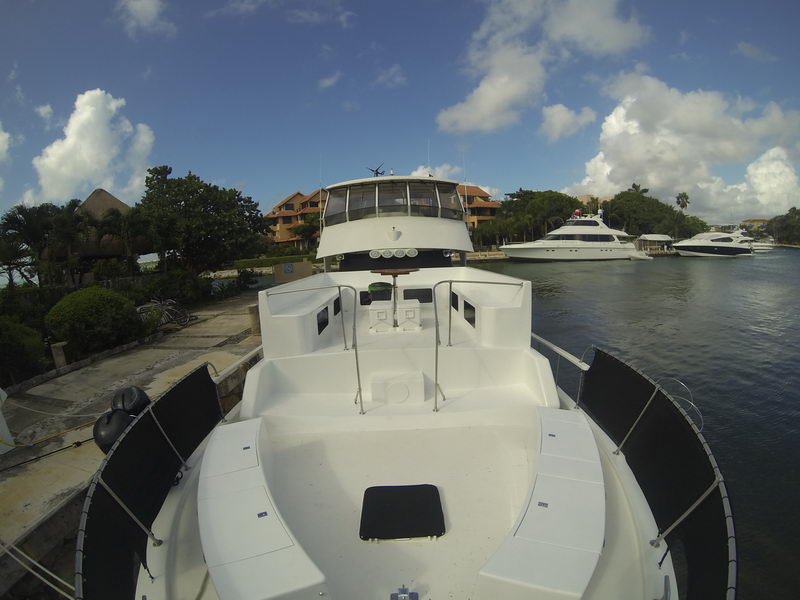 Bow view of the 72-ft Piratas De Tejas toward the Puerto Aventuras marina with villas and other yachts in the background