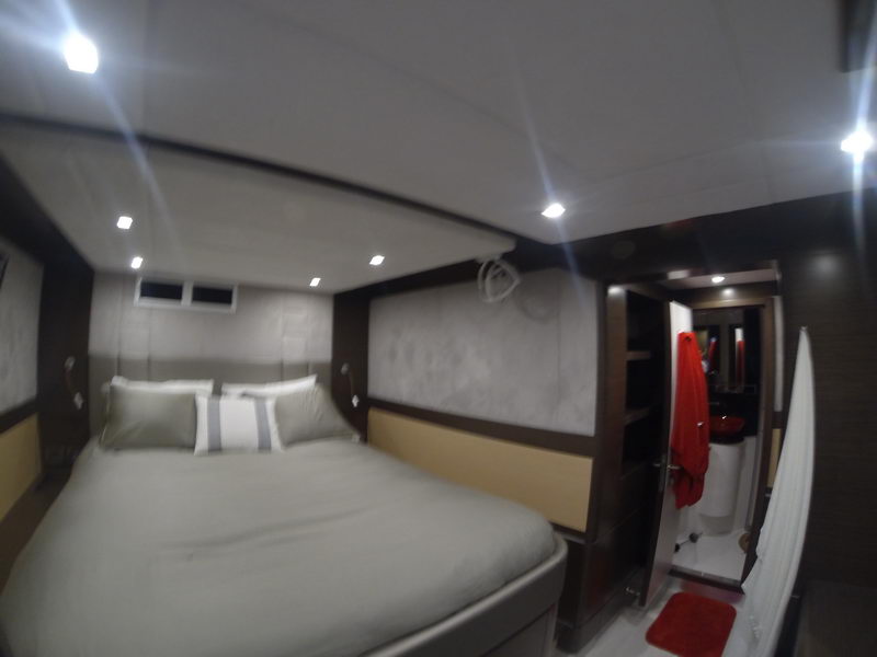 Guest stateroom with double bed and private ensuite bathroom aboard the 66 ft Sunreef luxury catamaran in Cancun